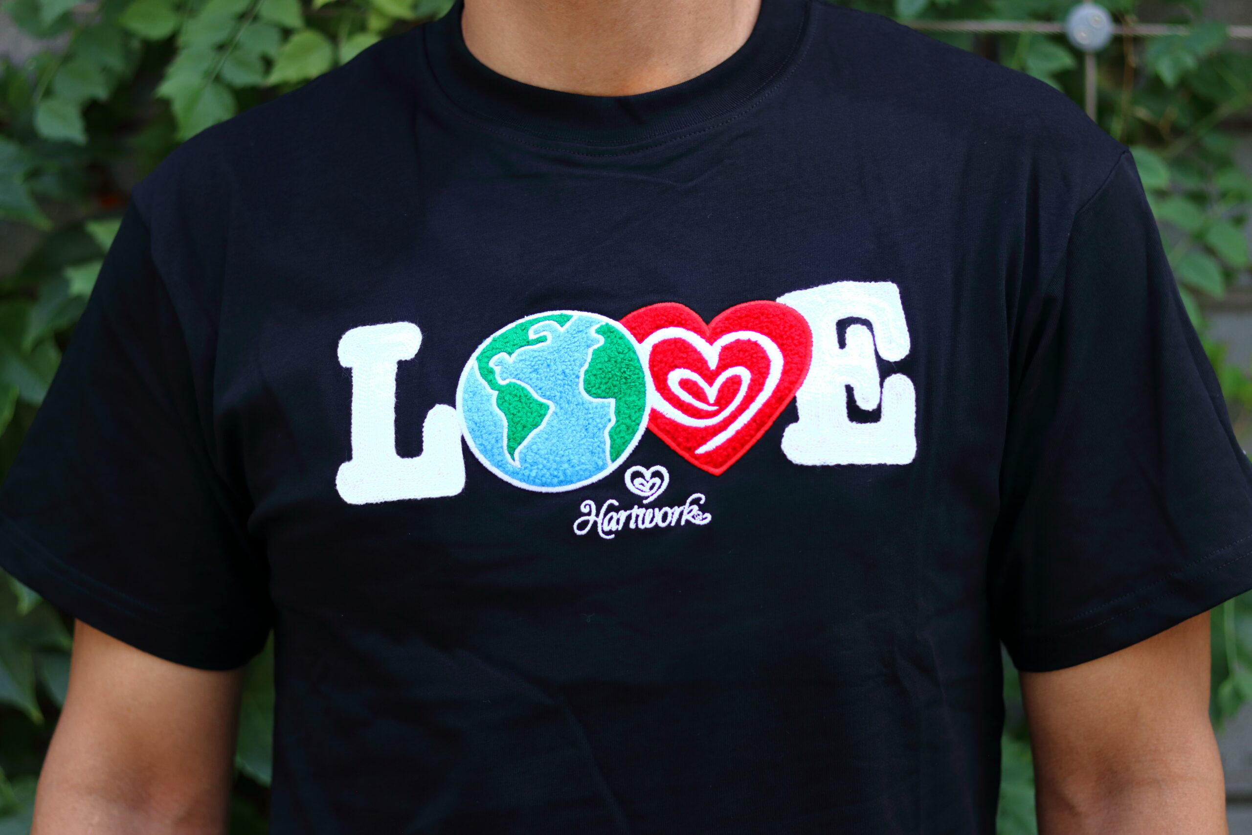 Model wearing the black Hartwork LOVE Patches Graphic Tee