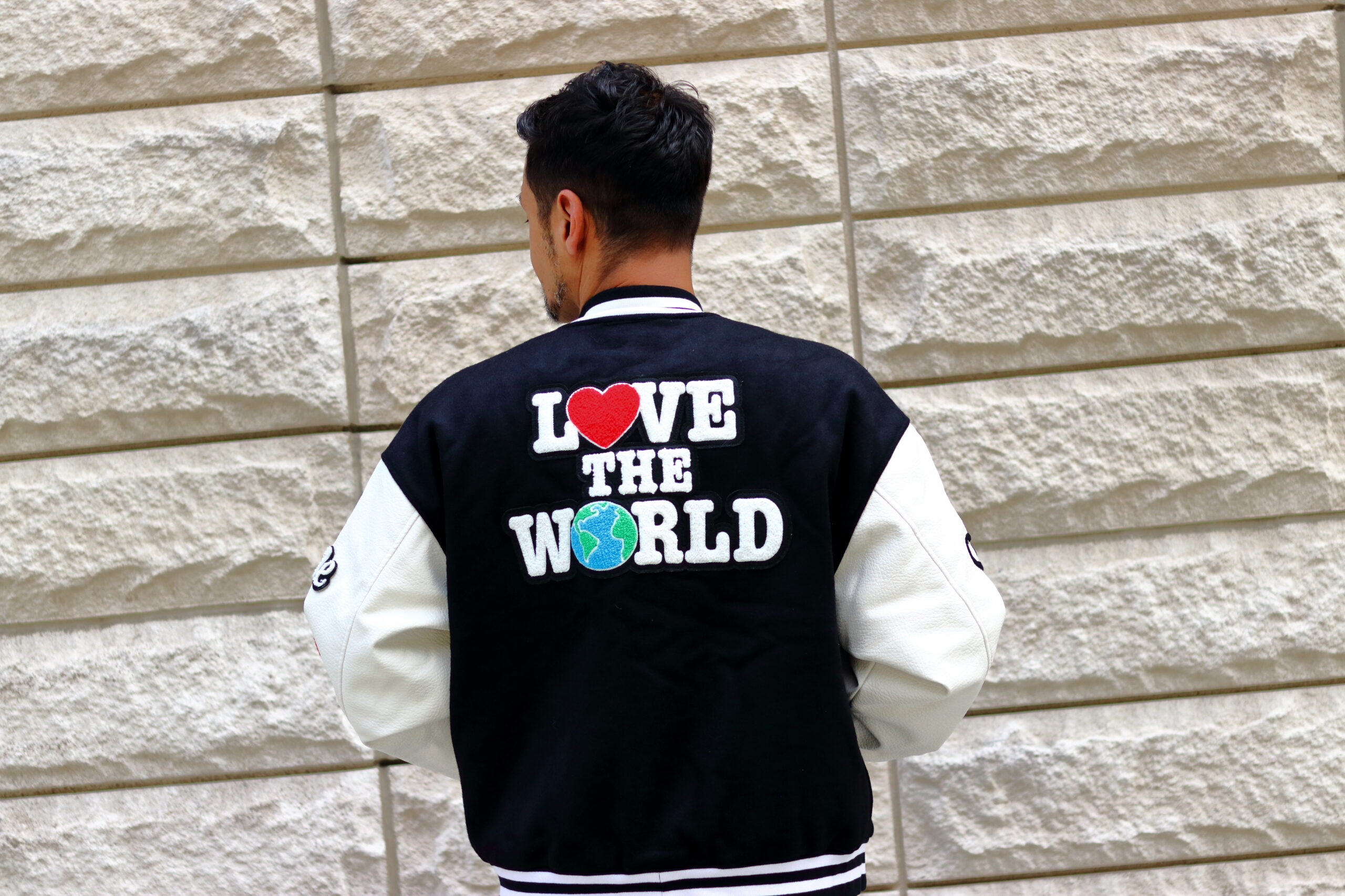 Model wearing the back of the Hartwork Varsity LOVE Jacket